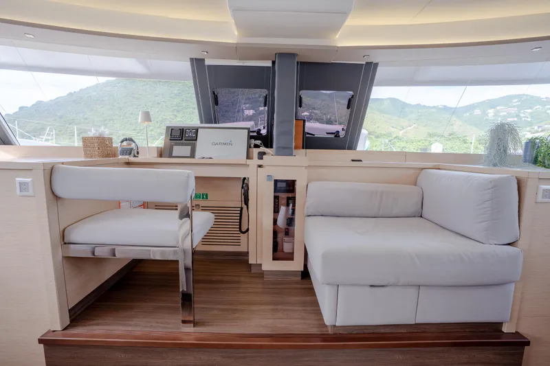  Yacht Photos Pics Luxurious interior of 2019 Fountaine Pajot Ipanema 58 yacht with modern seating and navigation equipment.