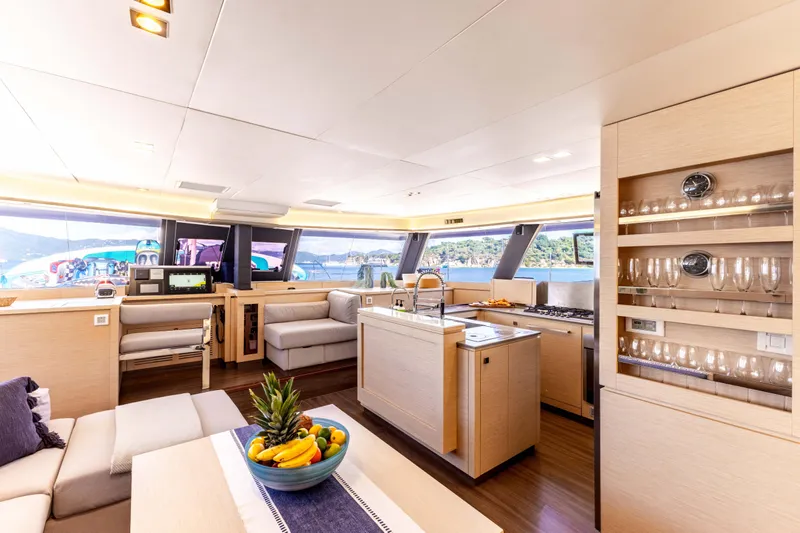  Yacht Photos Pics Luxurious interior of 2019 Fountaine Pajot Ipanema 58 catamaran with modern kitchen and seating area.