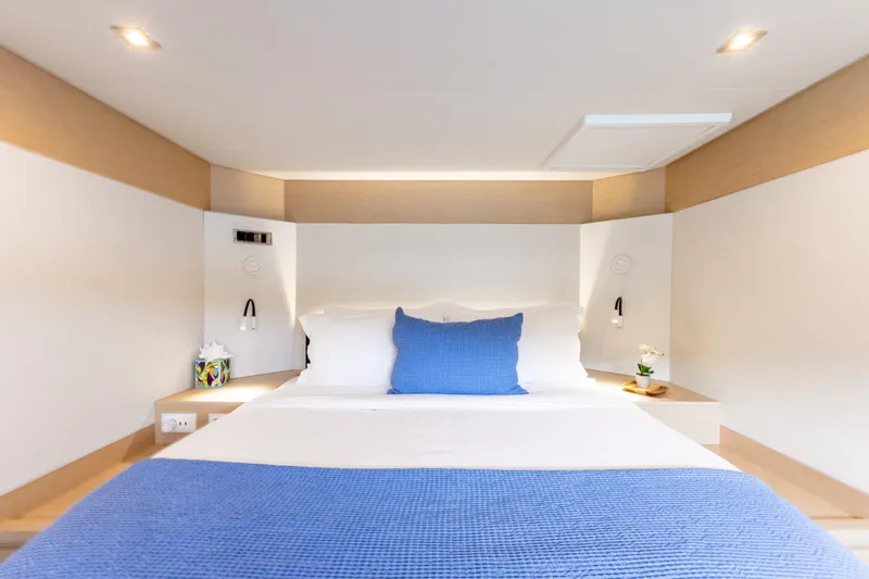  Yacht Photos Pics Luxurious bedroom interior on 2019 Fountaine Pajot Ipanema 58 yacht, featuring modern design.