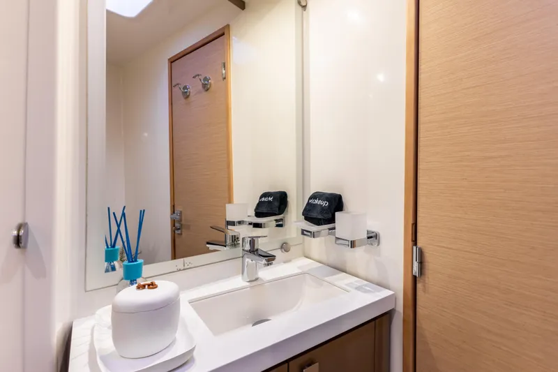  Yacht Photos Pics Modern bathroom interior on 2019 Fountaine Pajot Ipanema 58 yacht, featuring sleek sink and mirror.