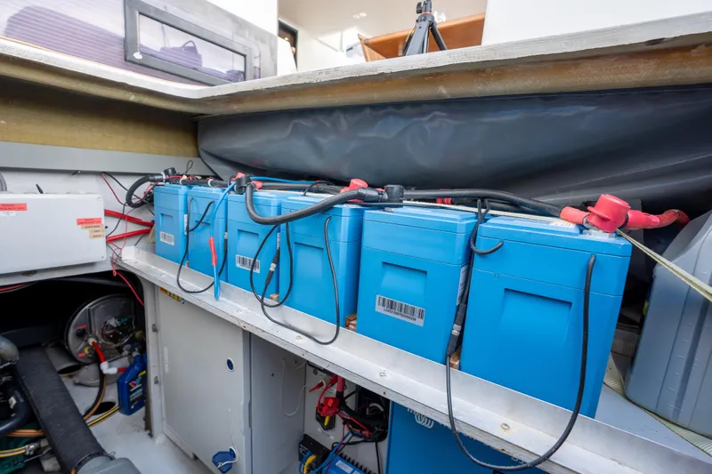  Yacht Photos Pics Battery compartment of 2019 Fountaine Pajot Ipanema 58 catamaran, featuring blue batteries.