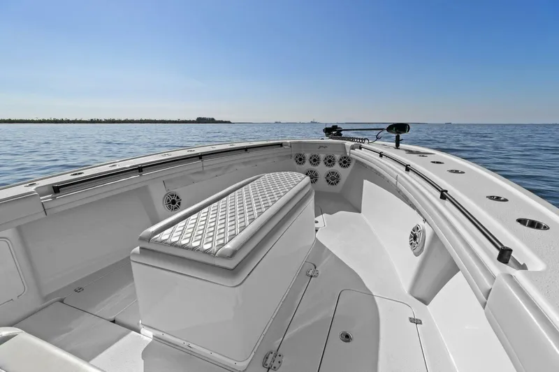 Rumble Fish Yacht Photos Pics 2021 Yellowfin 39 boat interior with seating, on calm ocean waters under clear blue sky.