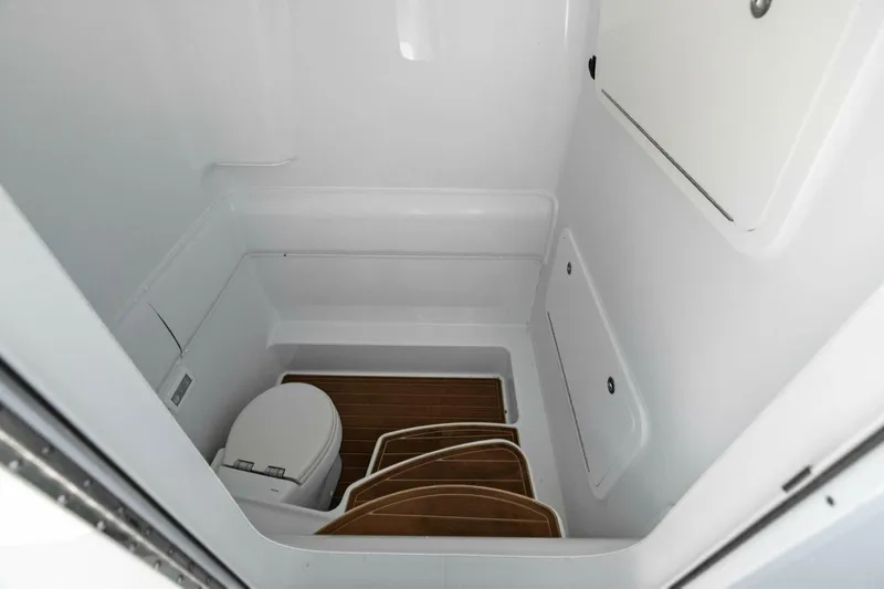 Rumble Fish Yacht Photos Pics 2021 Yellowfin 39 boat interior bathroom with toilet and wooden flooring.