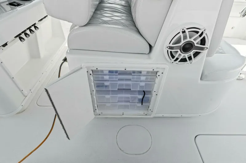 Rumble Fish Yacht Photos Pics 2021 Yellowfin 39 boat interior with open storage compartment and speaker.