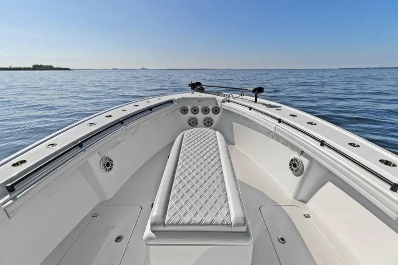 Rumble Fish Yacht Photos Pics 2021 Yellowfin 39 boat bow with cushioned seating on calm water.