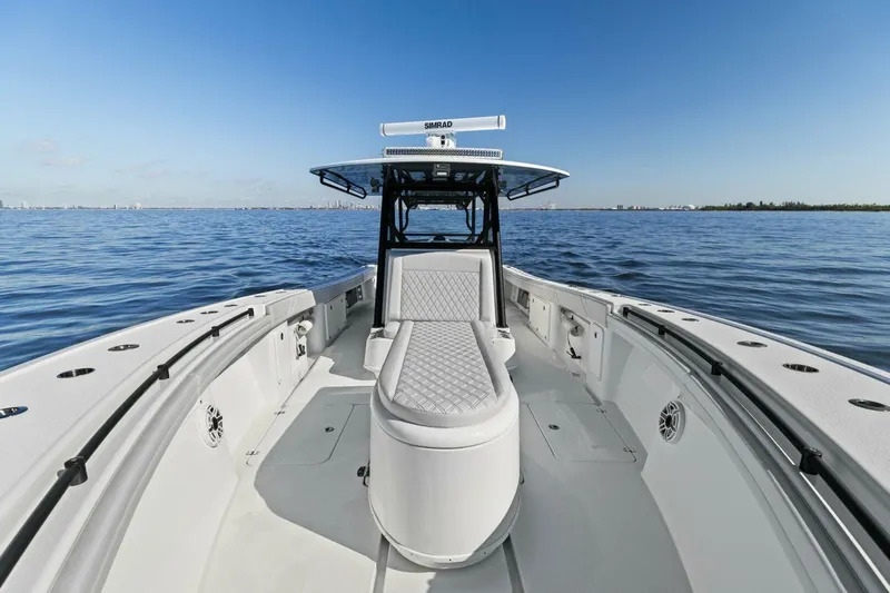 Rumble Fish Yacht Photos Pics 2021 Yellowfin 39 boat on calm water, showcasing spacious deck and seating.