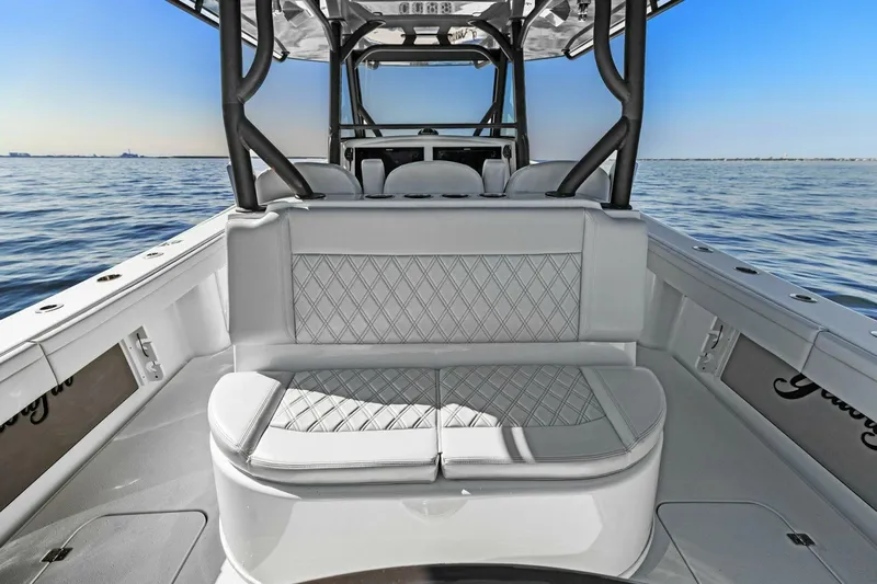 Rumble Fish Yacht Photos Pics 2021 Yellowfin 39 boat interior with cushioned seating, on calm ocean water.