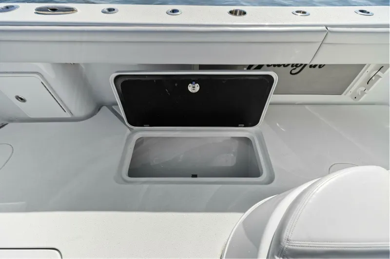 Rumble Fish Yacht Photos Pics 2021 Yellowfin 39 boat storage compartment with open hatch, showcasing sleek design and functionality.