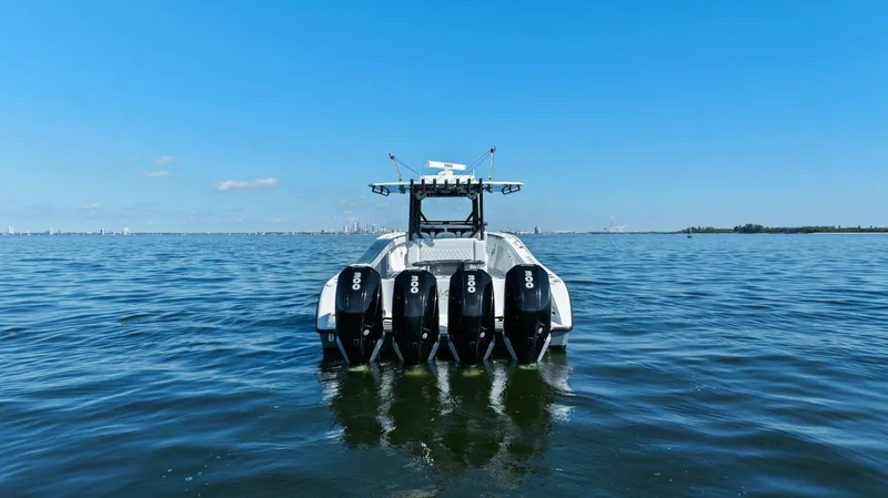 Rumble Fish Yacht Photos Pics 2021 Yellowfin 39 boat with four engines on open water under clear blue sky.