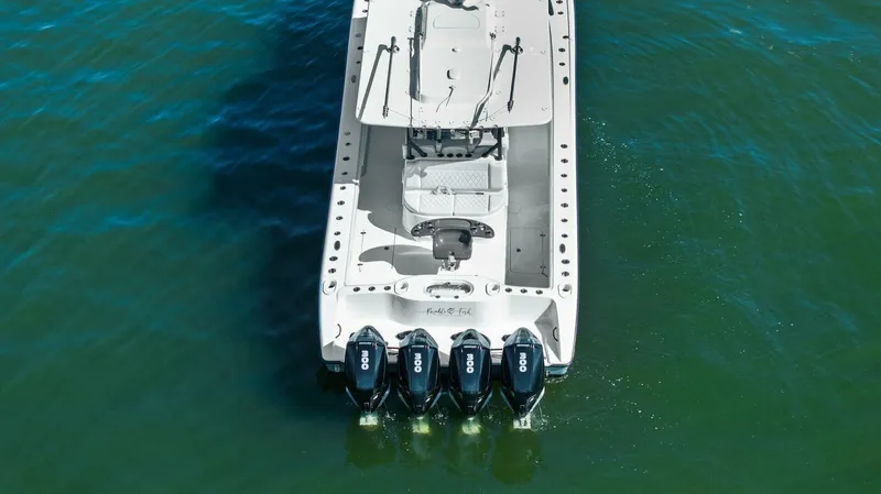 Rumble Fish Yacht Photos Pics 2021 Yellowfin 39 boat with four outboard engines on green water.