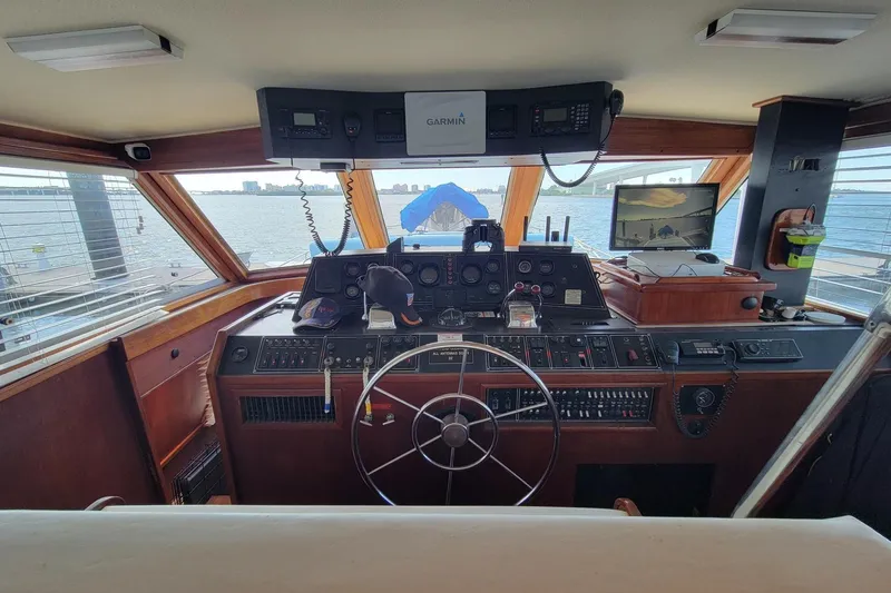 'charisma' Yacht Photos Pics Helm of 1985 Chris-Craft 500 Constellation yacht with navigation equipment and steering wheel.
