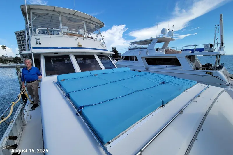 'charisma' Yacht Photos Pics 1985 Chris-Craft 500 Constellation yacht docked, with a person standing on deck.
