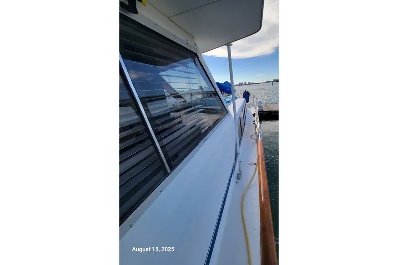 'charisma' Yacht Photos Pics 1985 Chris-Craft 500 Constellation yacht docked, side view with clear sky and water.