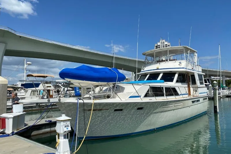 'charisma' Yacht Photos Pics 1985 Chris-Craft 500 Constellation yacht docked at marina under clear blue sky.
