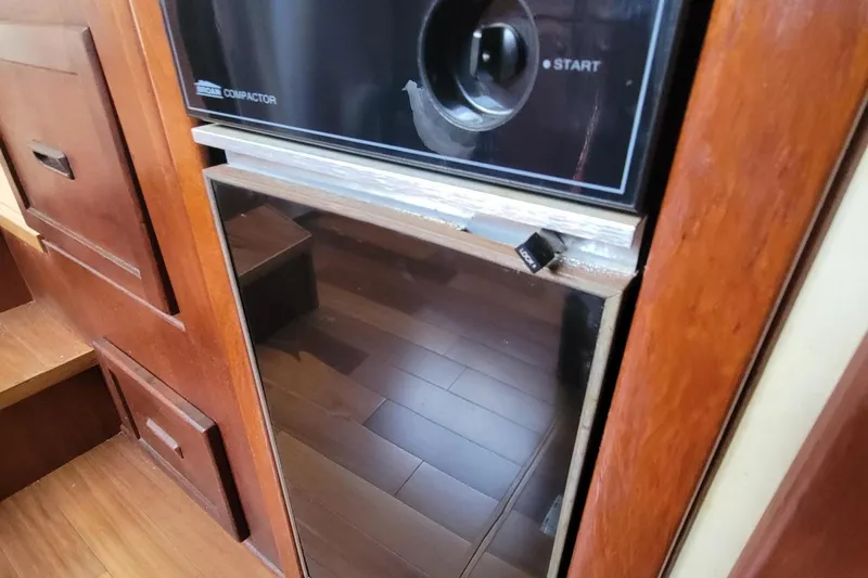 'charisma' Yacht Photos Pics 1985 Chris-Craft 500 Constellation interior with wooden cabinetry and built-in appliance.