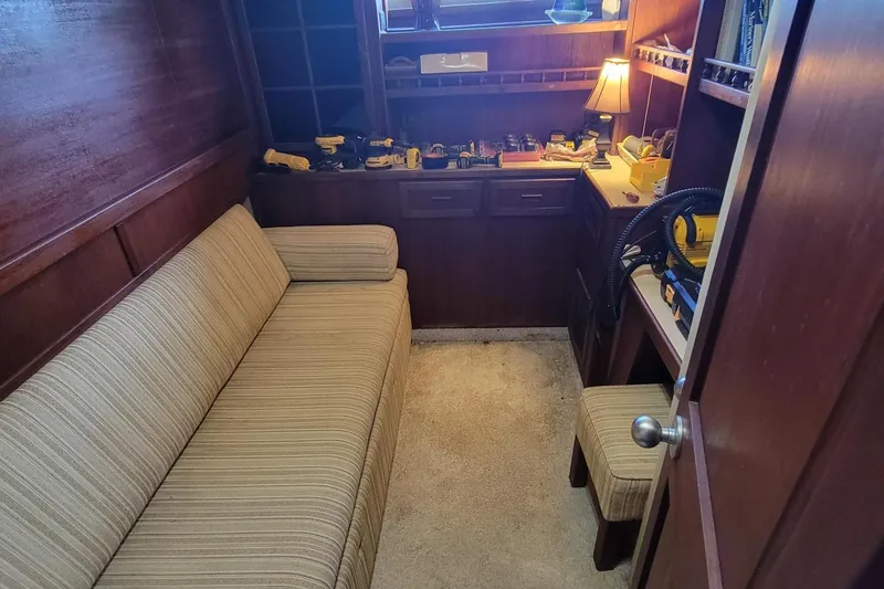 'charisma' Yacht Photos Pics Cozy interior of 1985 Chris-Craft 500 Constellation with sofa and workbench.