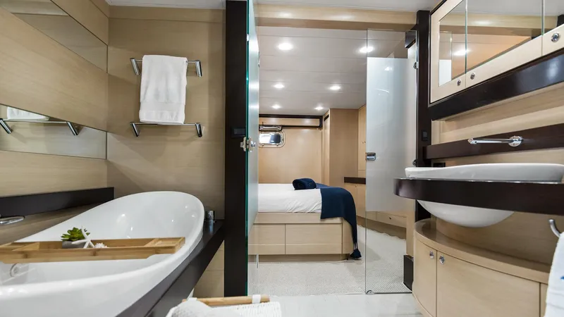 Texas T Yacht Photos Pics Luxurious bathroom and bedroom on 2009 Sulis Marine Expedition Yacht, featuring modern design and amenities.