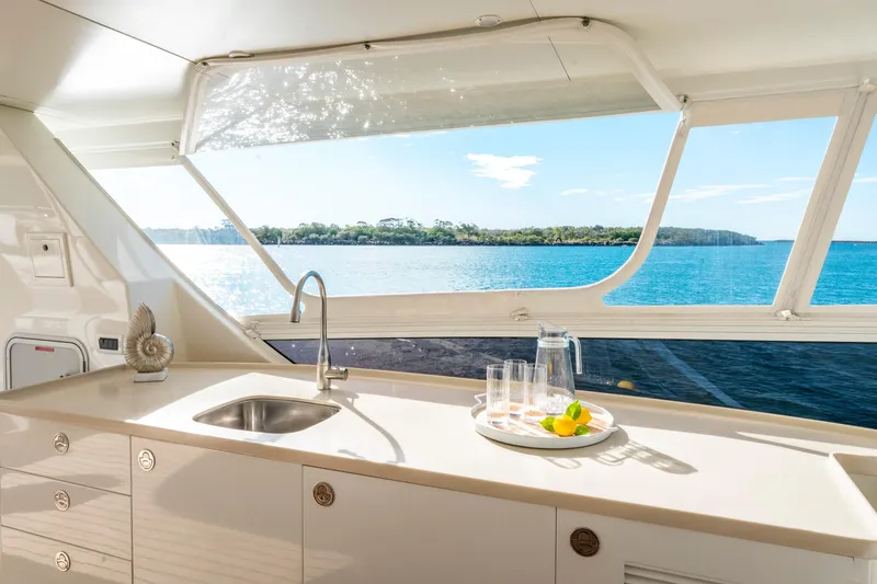 Texas T Yacht Photos Pics Luxurious yacht kitchen with ocean view, featuring sleek countertops and modern fixtures, 2009 Sulis Marine.