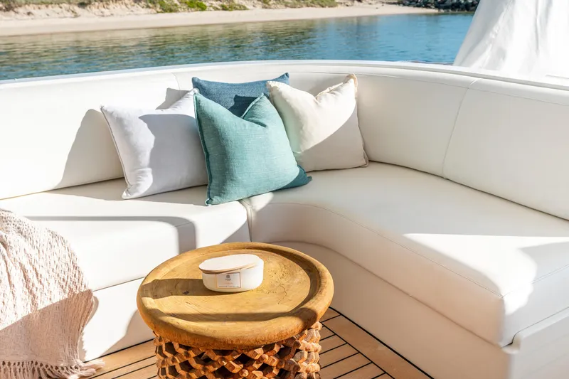 Texas T Yacht Photos Pics Luxurious seating area on 2009 Sulis Marine Expedition Yacht with cushions and wooden table.