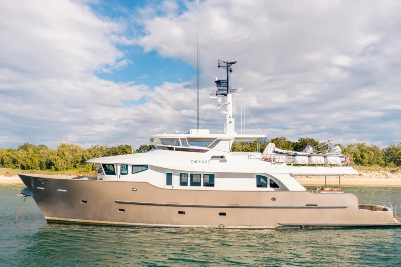 Texas T Yacht Photos Pics Custom 2009 Sulis Marine Expedition Yacht on calm waters, under a partly cloudy sky.