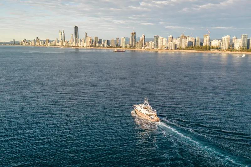 Texas T Yacht Photos Pics Custom Sulis Marine Expedition Yacht cruising near city skyline, 2009 model.