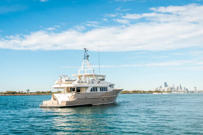 Texas T Yacht Photos Pics Custom 2009 Sulis Marine Expedition Yacht on calm waters with city skyline backdrop.