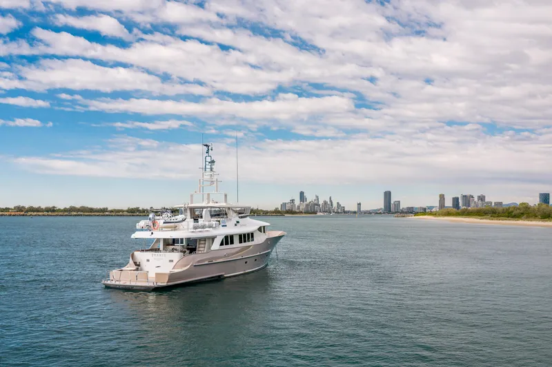 Texas T Yacht Photos Pics Custom 2009 Sulis Marine Expedition Yacht on calm waters with city skyline in background.