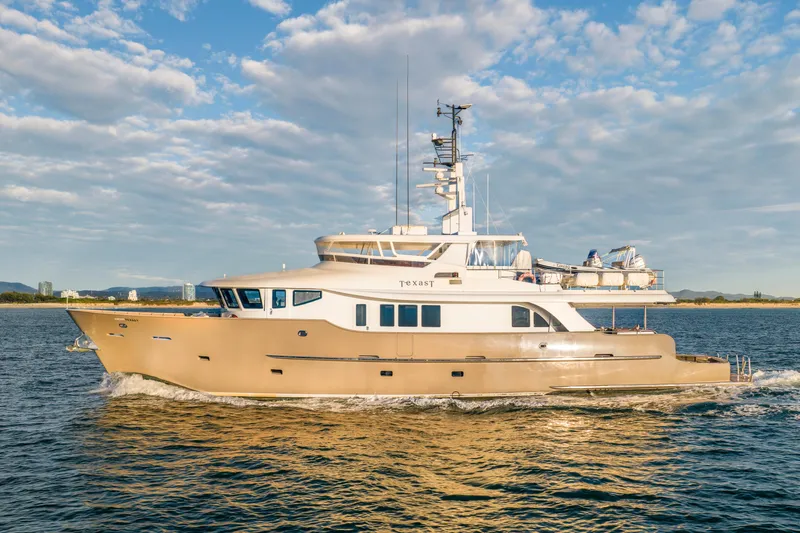 Texas T Yacht Photos Pics Custom 2009 Sulis Marine Expedition Yacht cruising on open water under a blue sky.