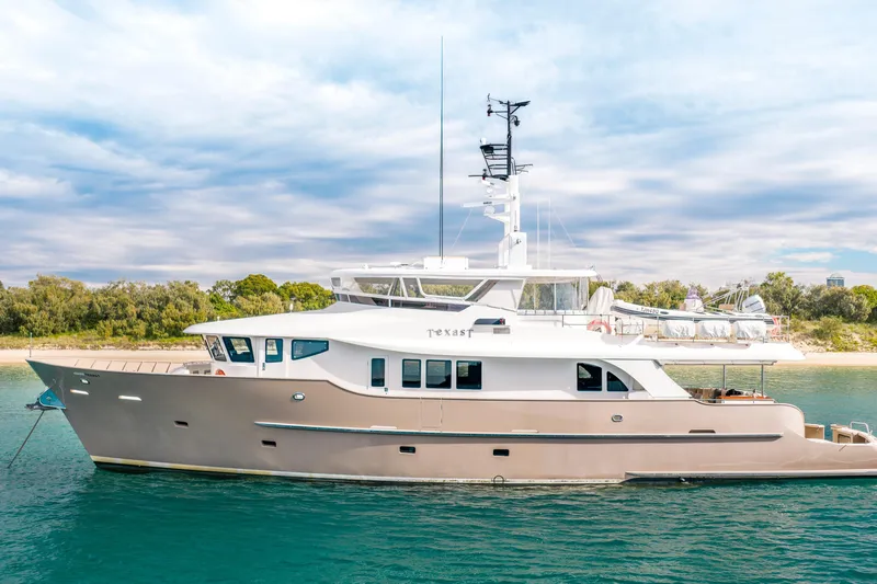 Texas T Yacht Photos Pics Custom 2009 Sulis Marine Expedition Yacht anchored near a scenic shoreline.