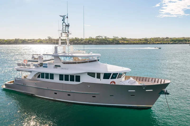 Texas T Yacht Photos Pics Custom 2009 Sulis Marine Expedition Yacht on serene water, sunny day, distant shoreline.