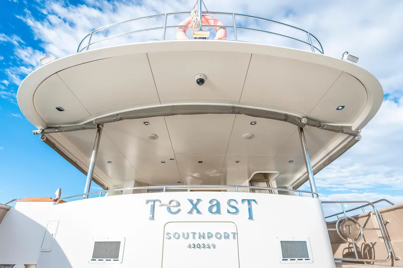 Texas T Yacht Photos Pics Custom 2009 Sulis Marine Expedition Yacht, docked under a clear blue sky.