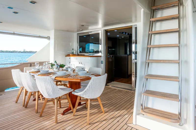 Texas T Yacht Photos Pics Outdoor dining area on 2009 Custom Sulis Marine Expedition Yacht, featuring elegant table setting.