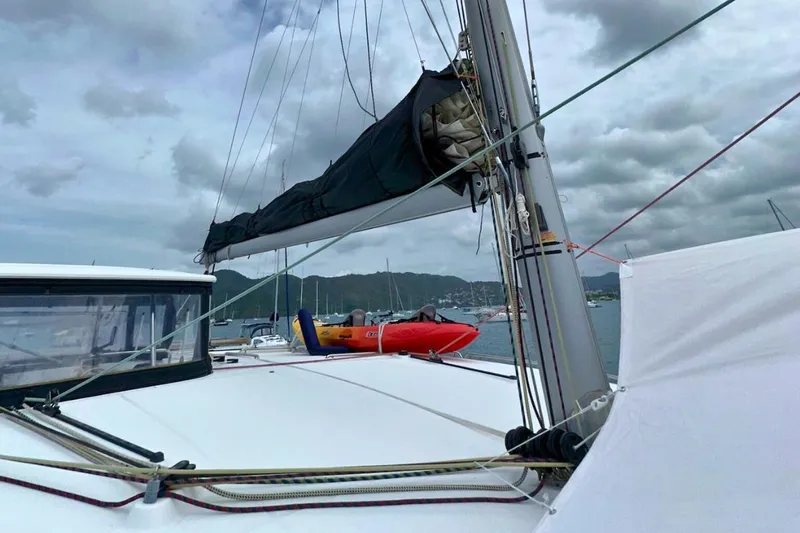 Sixtus Yacht Photos Pics 2016 Lagoon 450 s catamaran with sails down, docked in a scenic marina.