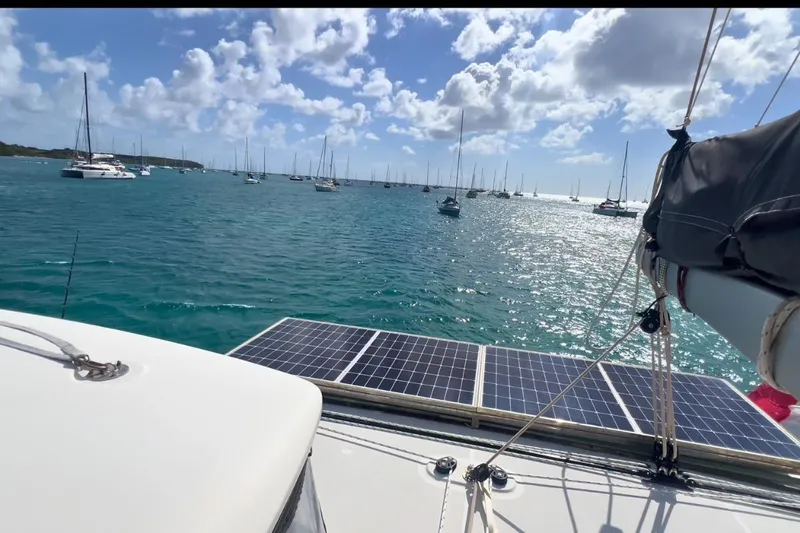 Sixtus Yacht Photos Pics Lagoon 450 s catamaran with solar panels, sailing in a sunlit bay, 2016 model.