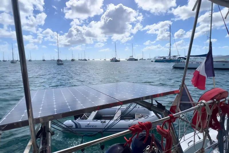 Sixtus Yacht Photos Pics Lagoon 450 s catamaran with solar panels and dinghy, anchored in a sunny marina, 2016 model.
