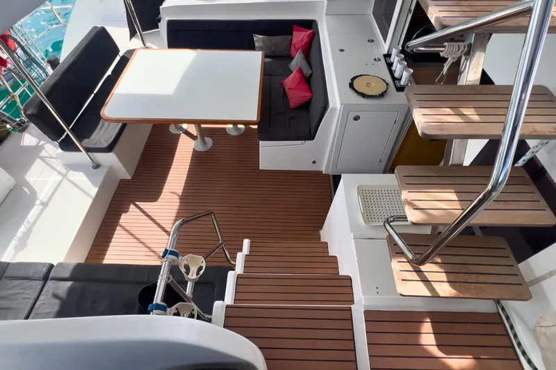 Sixtus Yacht Photos Pics Interior of 2016 Lagoon 450 s catamaran with wooden flooring and seating area.