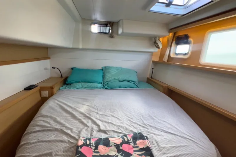 Sixtus Yacht Photos Pics Cozy bedroom interior of 2016 Lagoon 450 s catamaran with teal bedding and natural light.