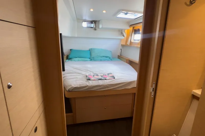 Sixtus Yacht Photos Pics Cozy bedroom interior of 2016 Lagoon 450 S catamaran with natural wood finish.