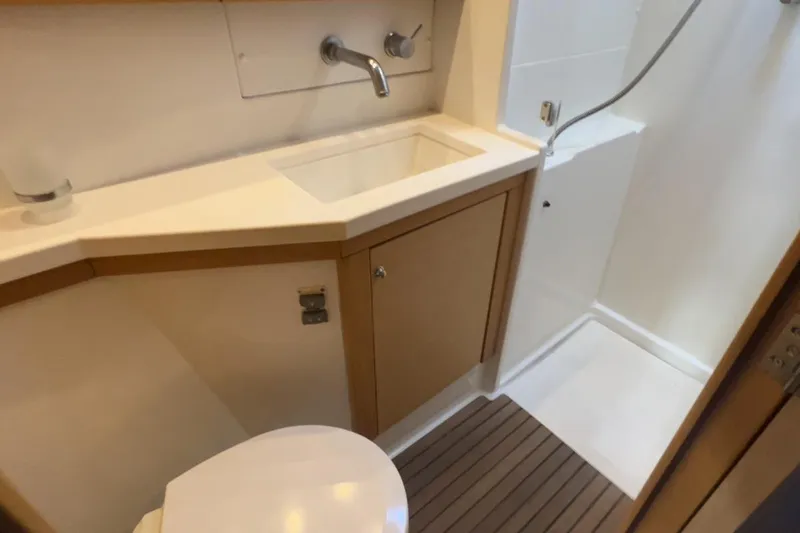 Sixtus Yacht Photos Pics Bathroom interior of 2016 Lagoon 450 s yacht, featuring sink, toilet, and shower area.