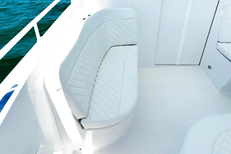  Yacht Photos Pics Luxurious white seating on 2024 Intrepid 41 Valor boat, with quilted upholstery and ocean view.