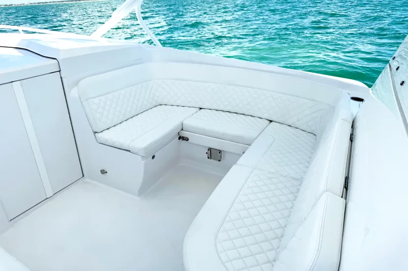  Yacht Photos Pics Luxurious white seating on 2024 Intrepid 41 Valor boat, overlooking clear blue water.