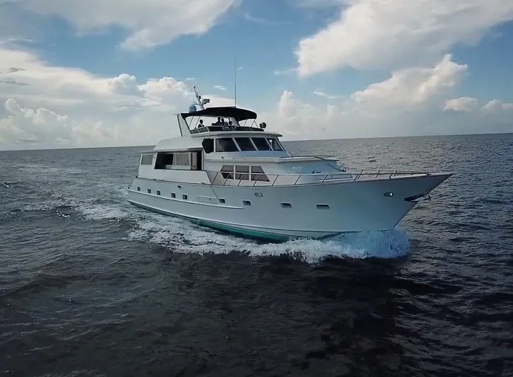 Sweet Freedom Yacht Photos Pics 1984 Broward CPMY yacht cruising on open sea.