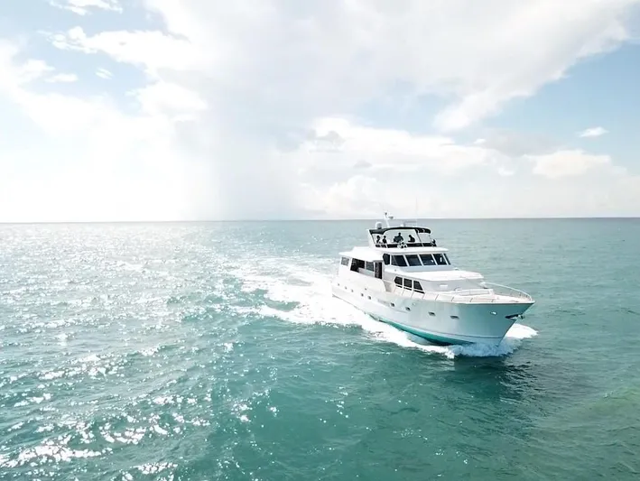 Sweet Freedom Yacht Photos Pics 1984 Broward CPMY yacht cruising on open sea under sunny skies.