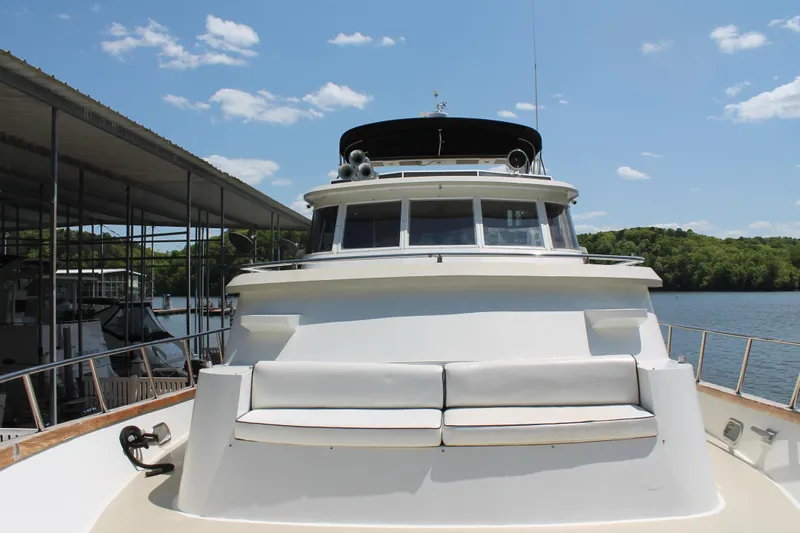 Sweet Freedom Yacht Photos Pics 1984 Broward CPMY Raised Pilothouse yacht at dock, sunny day.