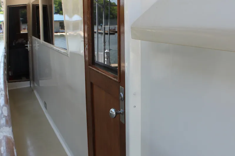 Sweet Freedom Yacht Photos Pics Side deck of 1984 Broward CPMY with wooden door.