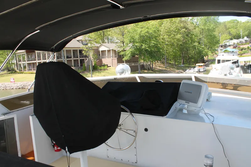 Sweet Freedom Yacht Photos Pics 1984 Broward CPMY Raised Pilothouse with covered helm station.