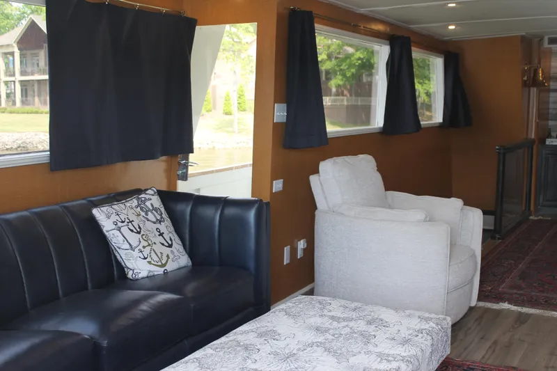 Sweet Freedom Yacht Photos Pics Interior of a 1984 Broward CPMY yacht with sofas and windows.