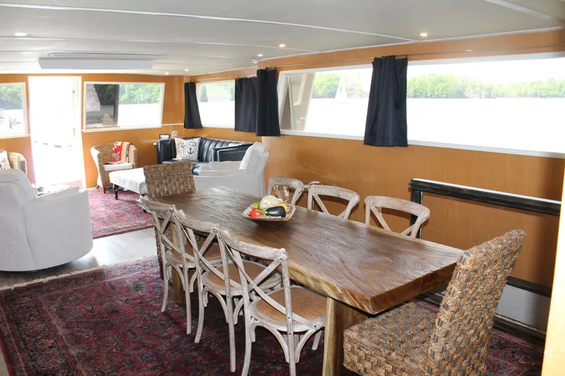 Sweet Freedom Yacht Photos Pics Interior of a 1984 Broward CPMY yacht with dining table.