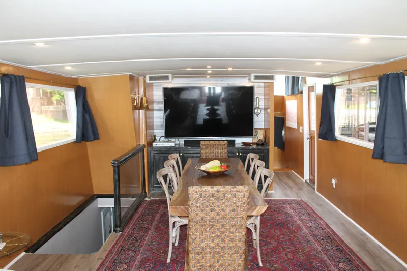 Sweet Freedom Yacht Photos Pics Interior of 1984 Broward CPMY with dining area and TV.