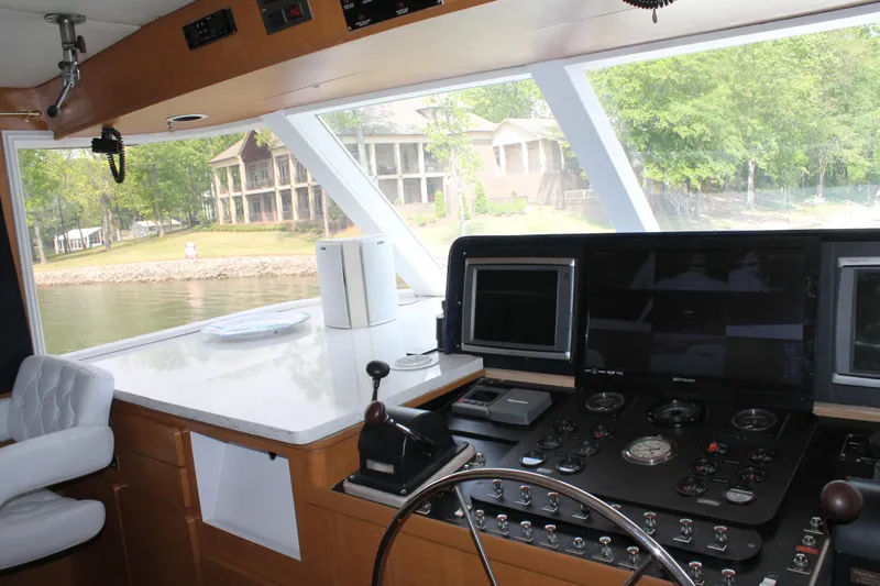 Sweet Freedom Yacht Photos Pics 1984 Broward CPMY pilothouse interior with riverbank view.